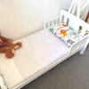Image of Piddle Pad Bed Wetting and Potty training mattress protector on bed.
